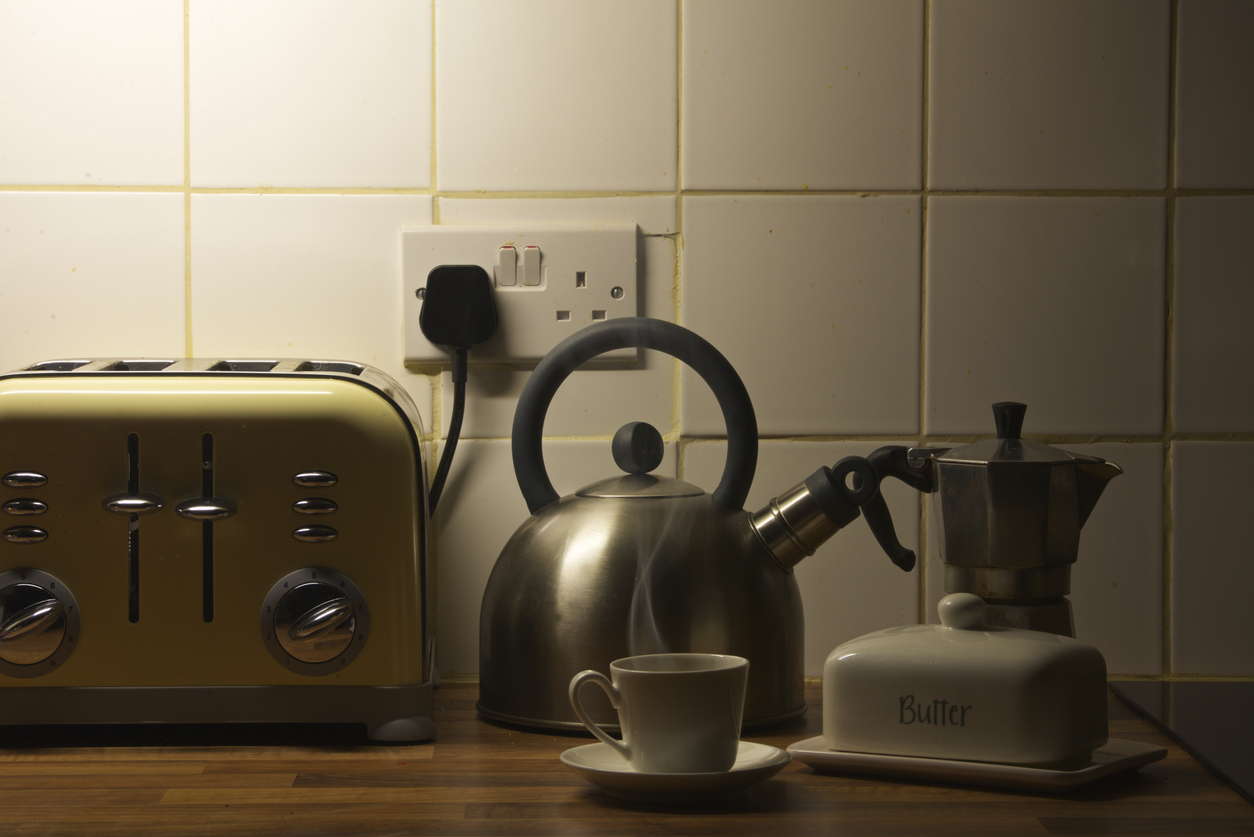 Kitchen counter, yellow toaster focus, neatly arranged appliances, morning sunlight, editorial travel photo, no people.