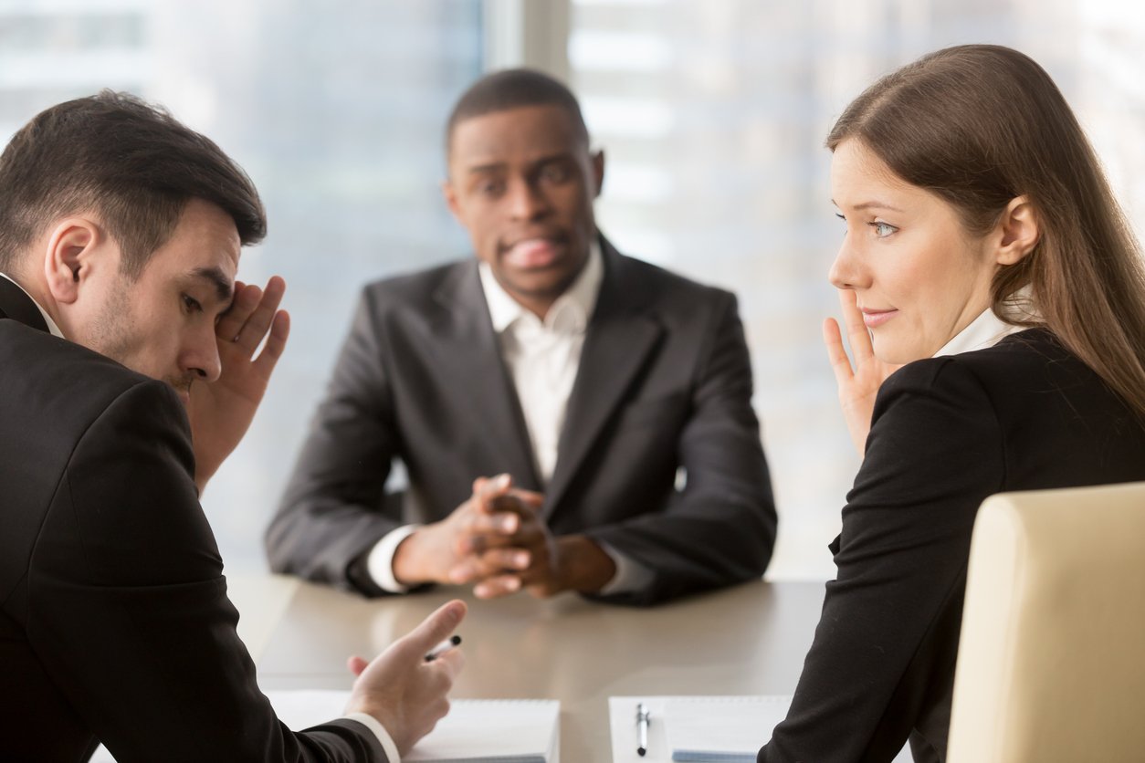Conference room, tense boardroom scene, trio at meeting table, even indoor light, documentary style, three professionals.