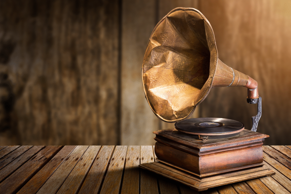 Rustic wooden table, gramophone with brass horn, centered composition, soft daylight, editorial travel photo, no people.