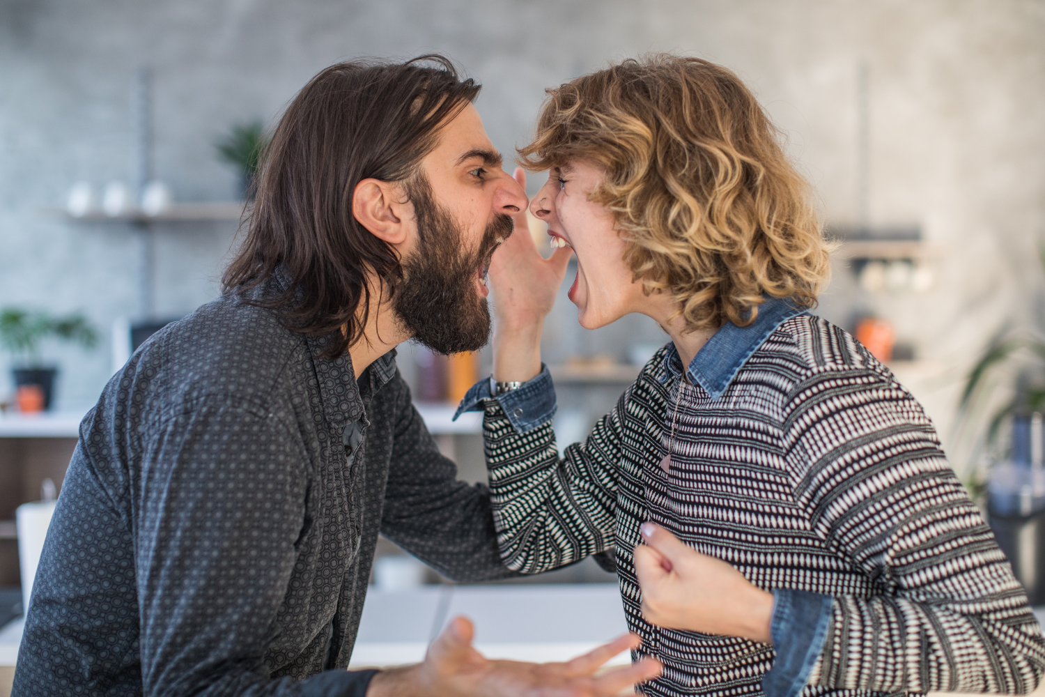 Kitchen interior, couple arguing face-to-face, close composition, daytime natural light, documentary style, people present.