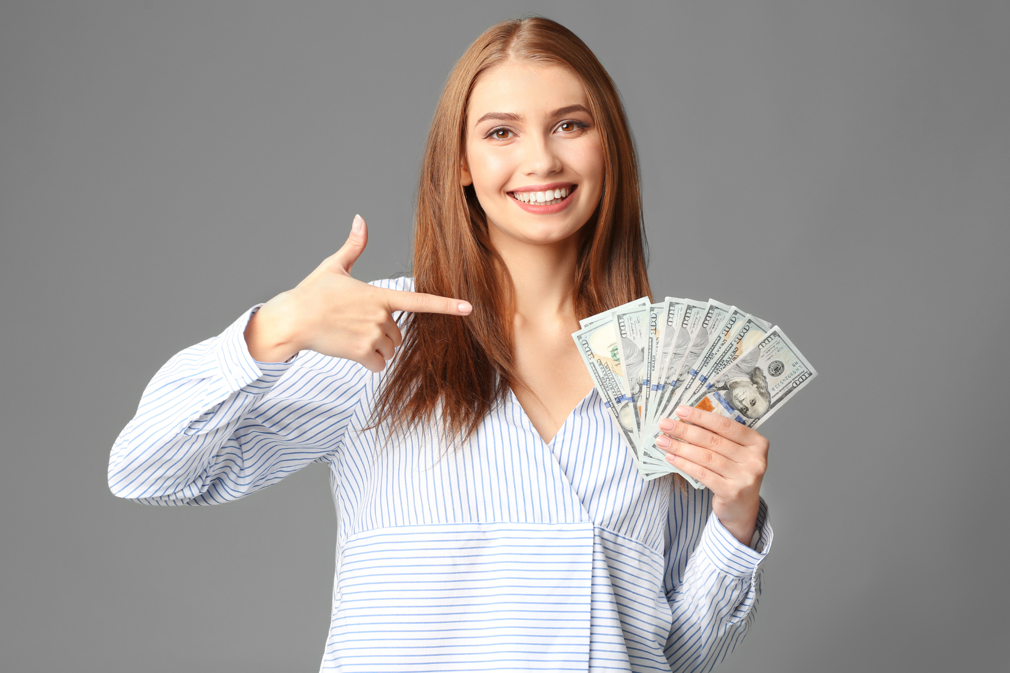 Studio, woman with fan of hundred-dollar bills, front-facing composition, bright lighting, editorial photo, with people.